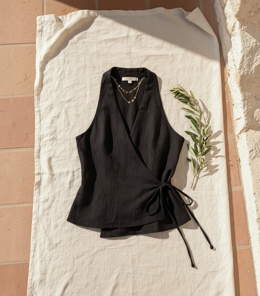 Top cruzado negro de lino Clarvyna con escote en V y lazada lateral, ideal para un look elegante y fresco.